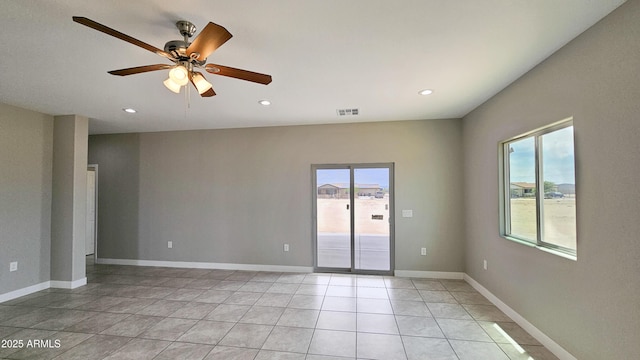 spare room with a ceiling fan, recessed lighting, and light tile patterned floors