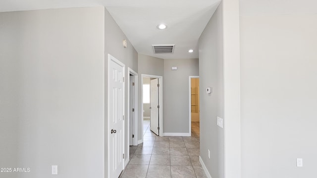 hall featuring recessed lighting and baseboards