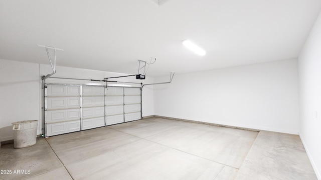 garage featuring a garage door opener and baseboards