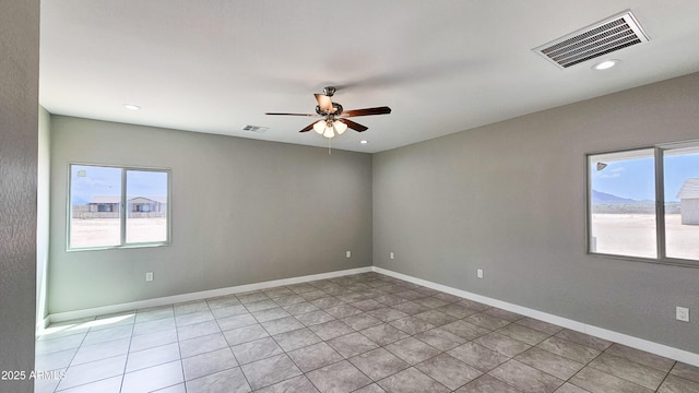 unfurnished room with plenty of natural light, ceiling fan, recessed lighting, light tile patterned floors, and baseboards