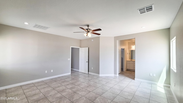 unfurnished bedroom with light tile patterned floors, baseboards, recessed lighting, ceiling fan, and connected bathroom