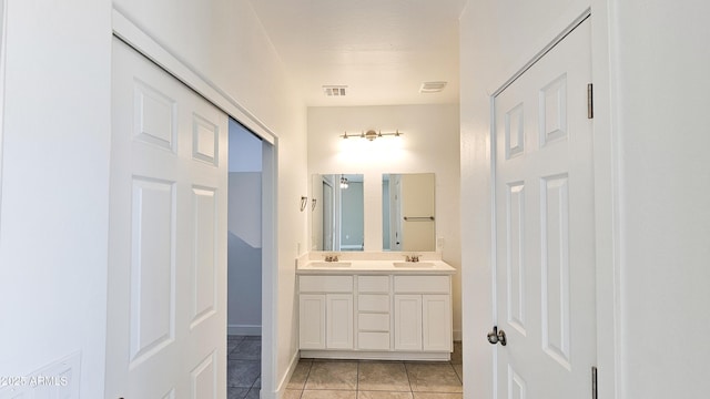 full bathroom with double vanity and tile patterned flooring