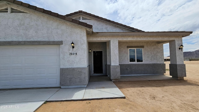 view of front of property with stucco siding and a garage