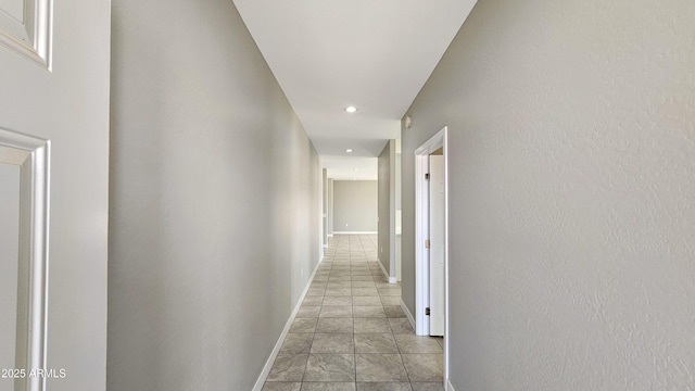 hall featuring recessed lighting and baseboards