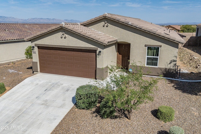 1635 W Cottonwood Bluffs Dr, Benson, AZ 85602 - view of front facade with stucco siding, a garage, concrete driveway, a tiled roof, and a mountain view