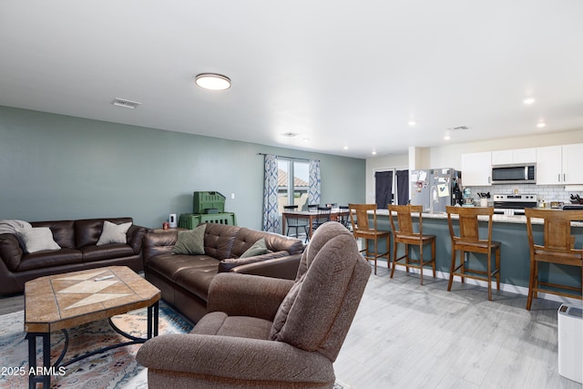 1635 W Cottonwood Bluffs Dr, Benson, AZ 85602 - living area with light wood-style floors and recessed lighting
