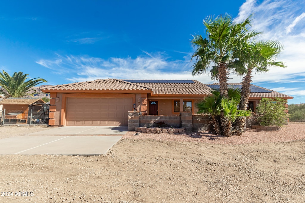 view of front of house with a garage and solar panels