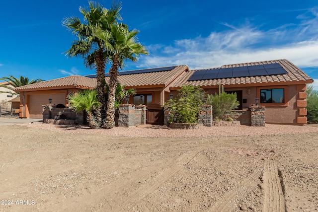 view of front of home with solar panels and a garage