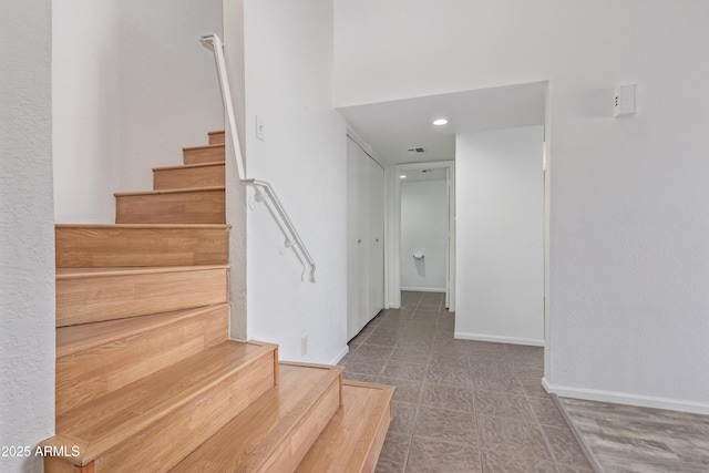 staircase featuring baseboards