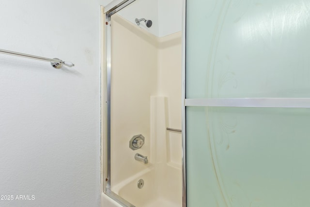 full bath featuring bath / shower combo with glass door