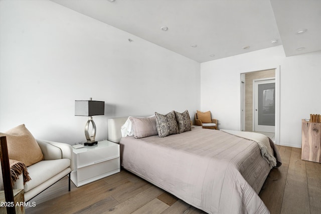 7180 E Kierland Blvd Unit 814, Scottsdale, AZ 85254 - bedroom with wood-type flooring and recessed lighting