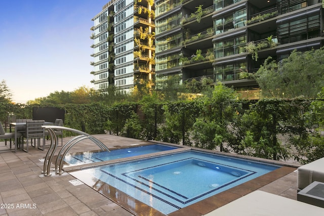 7180 E Kierland Blvd Unit 814, Scottsdale, AZ 85254 - pool at dusk with a hot tub and a patio area