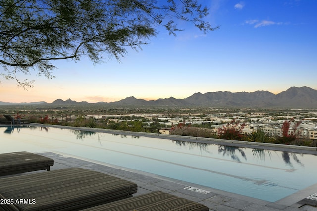 7180 E Kierland Blvd Unit 814, Scottsdale, AZ 85254 - pool at dusk with a mountain view and a pool