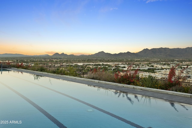 7180 E Kierland Blvd Unit 814, Scottsdale, AZ 85254 - pool at dusk with a mountain view