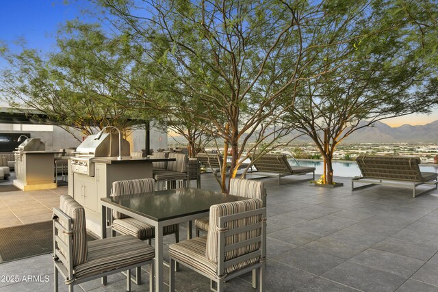 7180 E Kierland Blvd Unit 814, Scottsdale, AZ 85254 - view of patio with an outdoor pool, a mountain view, and outdoor dining area