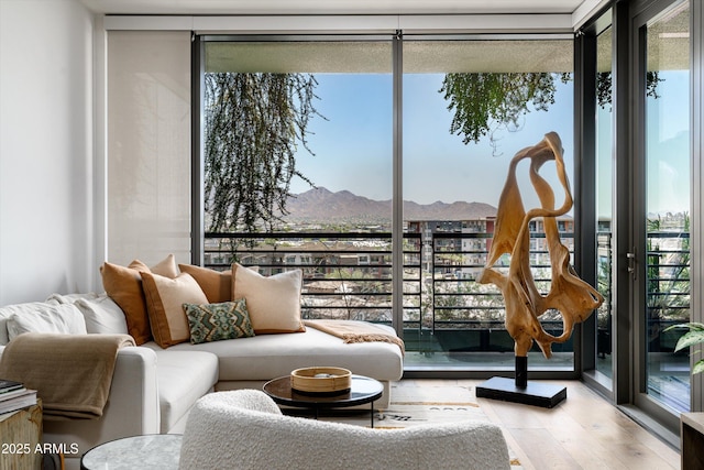 7180 E Kierland Blvd Unit 814, Scottsdale, AZ 85254 - sitting room featuring a wall of windows, a mountain view, and wood finished floors