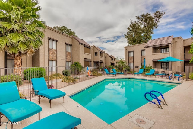 pool featuring a residential view and fence