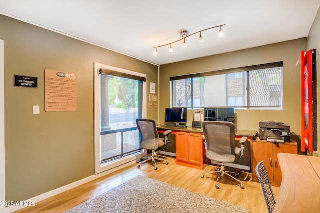 office area with baseboards, rail lighting, and light wood-style floors