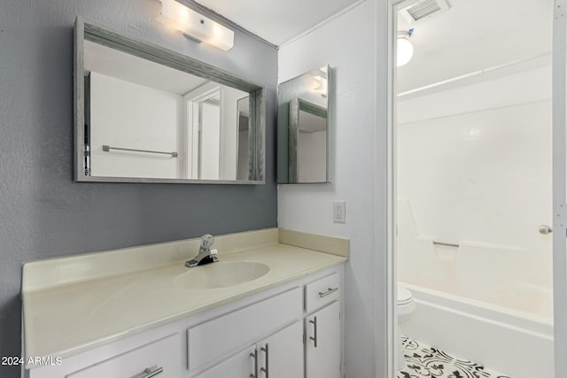 full bathroom featuring bathing tub / shower combination, vanity, and toilet