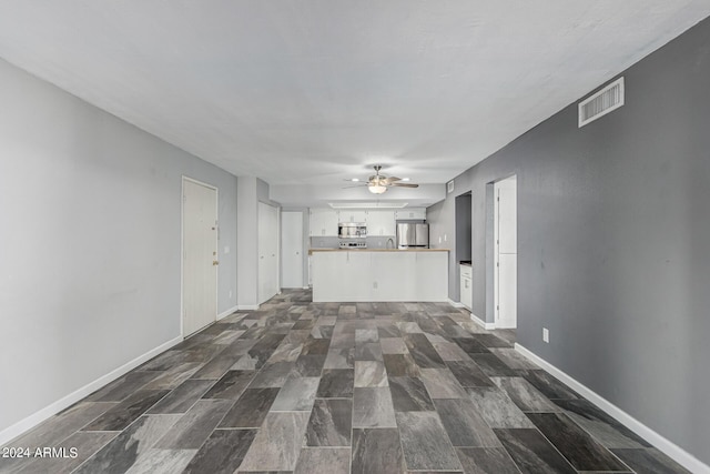 unfurnished living room featuring ceiling fan