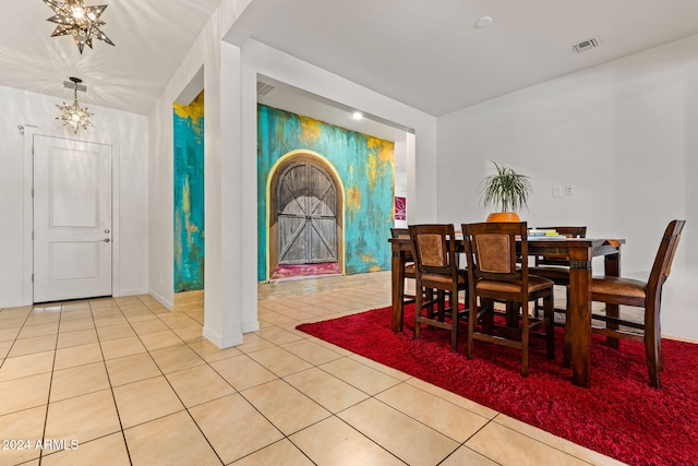 dining area with a chandelier, tile patterned flooring, and visible vents