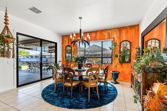 dining room with light tile patterned floors, visible vents, and an inviting chandelier