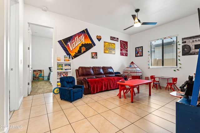 living area featuring light tile patterned floors and ceiling fan