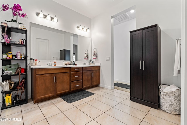 full bathroom featuring double vanity, baseboards, visible vents, tile patterned floors, and a sink