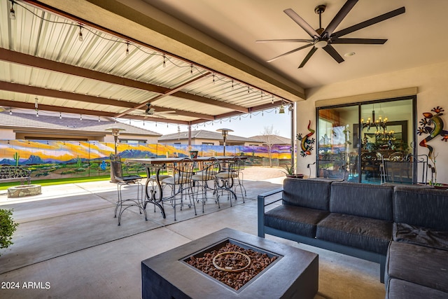 view of patio with ceiling fan, outdoor dining space, and an outdoor living space with a fire pit