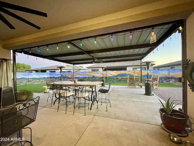 view of patio featuring outdoor dining area and fence