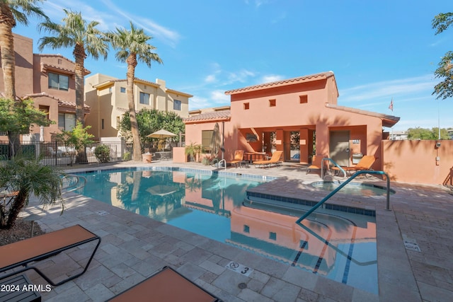 view of pool featuring a patio area and a hot tub