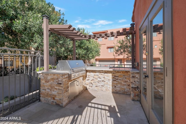 view of patio / terrace featuring a pergola, grilling area, and an outdoor kitchen