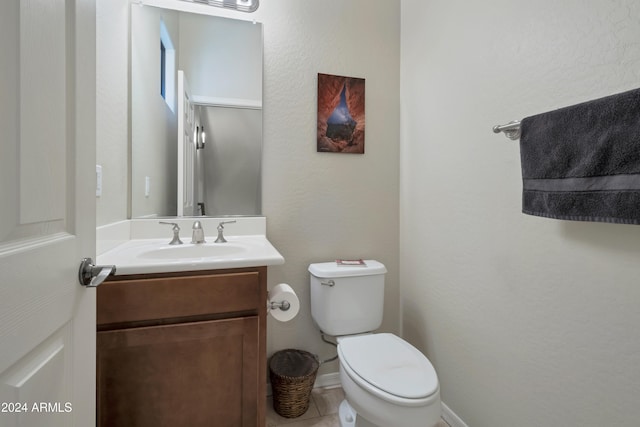 bathroom with tile patterned floors, vanity, and toilet