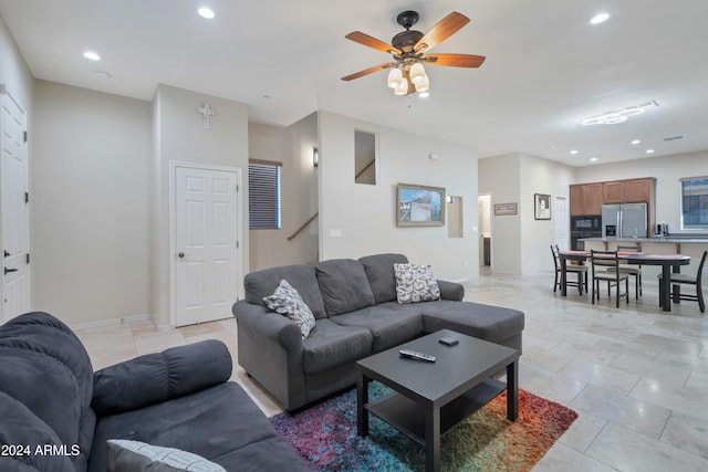 tiled living room featuring ceiling fan