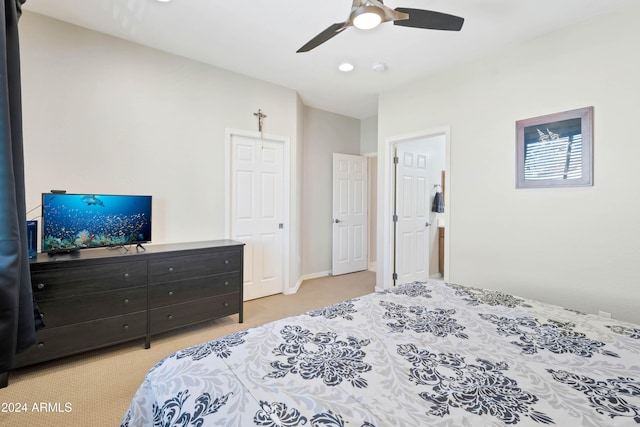 bedroom with ceiling fan and light carpet