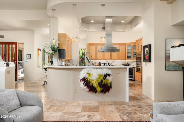 kitchen featuring decorative backsplash, island range hood, stainless steel double oven, and hanging light fixtures