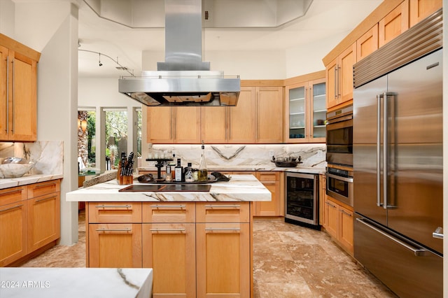 kitchen featuring stainless steel appliances, wine cooler, island exhaust hood, decorative backsplash, and a kitchen island