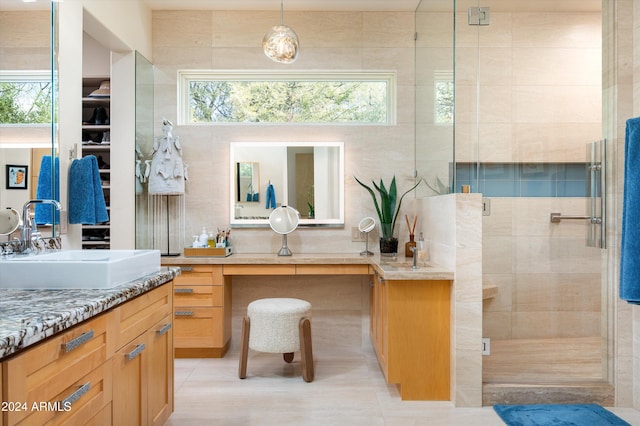 bathroom with tile patterned floors, vanity, and tile walls