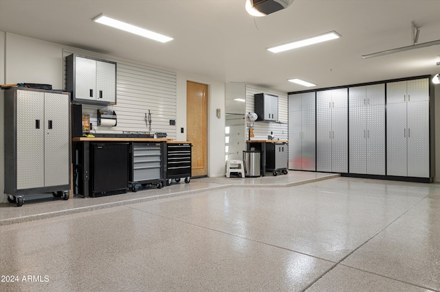 garage featuring a workshop area and a garage door opener