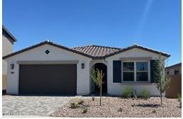 5027 W Hardtack Trl, Laveen, AZ 85339 - view of front of home with an attached garage, a tile roof, driveway, and stucco siding