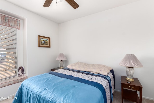 bedroom with ceiling fan, carpet, and baseboards