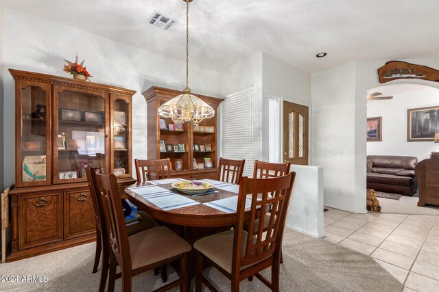 dining room with a notable chandelier, baseboards, and carpet flooring