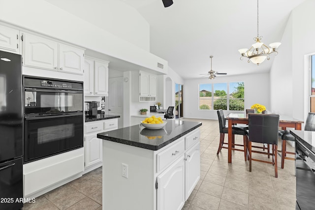 kitchen with pendant lighting, white cabinetry, a center island, black appliances, and light tile patterned flooring