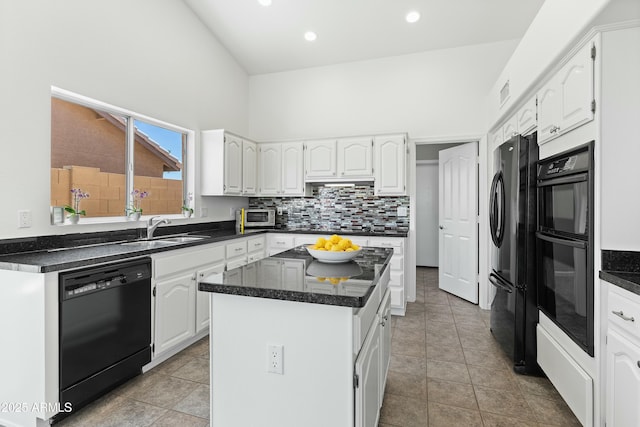 kitchen featuring high vaulted ceiling, white cabinetry, sink, a center island, and black appliances