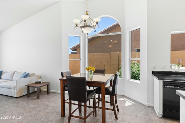 tiled dining room featuring high vaulted ceiling and a notable chandelier