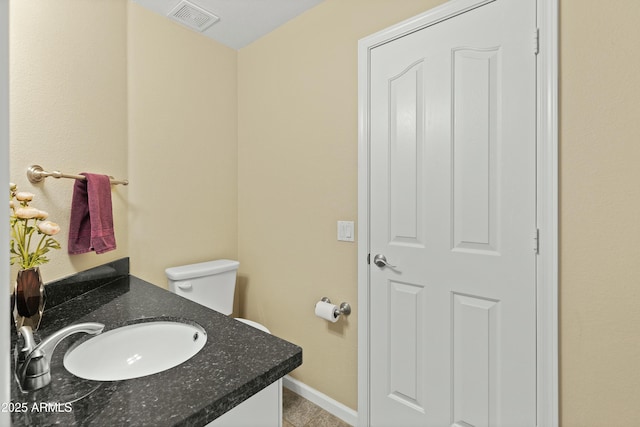 bathroom featuring tile patterned flooring, vanity, and toilet