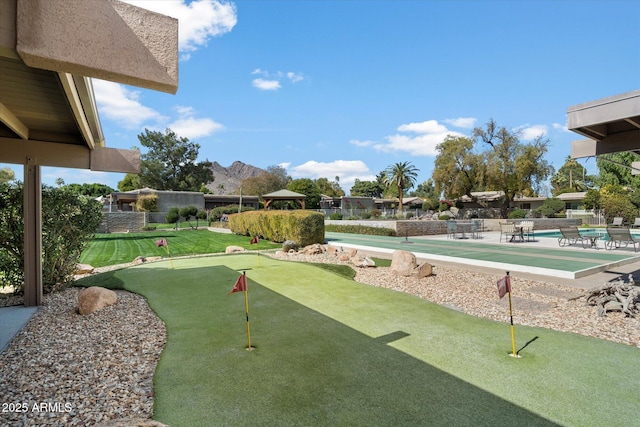 view of community with a patio and fence