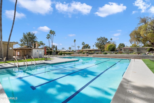 pool featuring a patio and fence