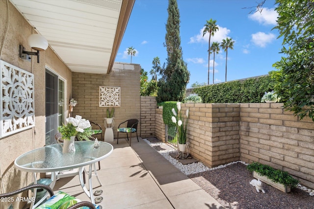 view of patio / terrace with outdoor dining area and fence