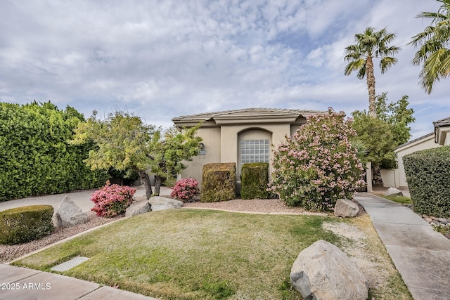 mediterranean / spanish-style home with a front lawn